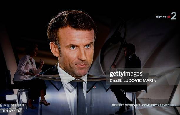 In this screen shot made in Paris on October 26, 2022 French president Emmanuel Macron speaks during an interview by French journalist and TV host...