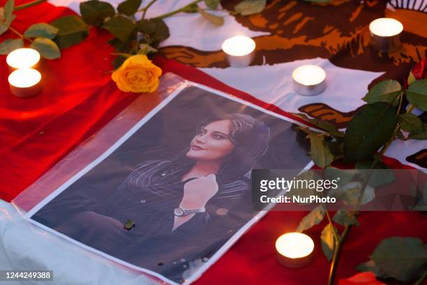 Picture of Mahsa Amini, flowers and candles are seen during the mourning mark 40 days of death of Mahsa Amini in Cologne, Germany on Oct 26, 2022