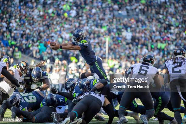 Seattle Seahawks quarterback Geno Smith dives of the top for a touchdown during an NFL football game against the Jacksonville Jaguars Sunday, Oct. 31...