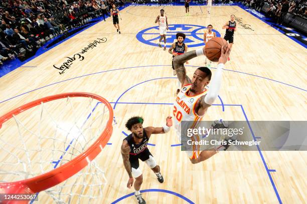 John Collins of the Atlanta Hawks drives to the basket against the Detroit Pistons on October 26, 2022 at Little Caesars Arena in Detroit, Michigan....