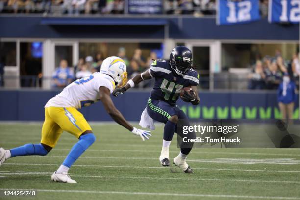 Seattle Seahawks running back Alex Collins runs with the ball during an NFL preseason football game between the Seattle Seahawks and the Los Angeles...