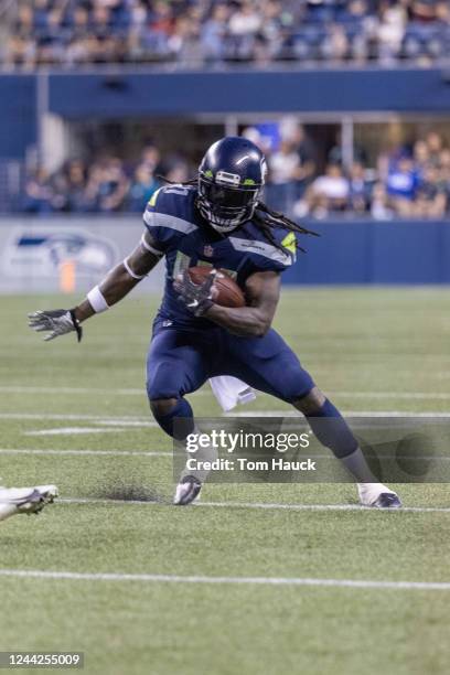 Seattle Seahawks running back Alex Collins runs with the ball during an NFL preseason football game between the Seattle Seahawks and the Los Angeles...