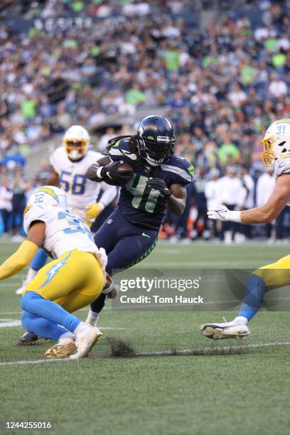 Seattle Seahawks running back Alex Collins runs with the ball during an NFL preseason football game between the Seattle Seahawks and the Los Angeles...