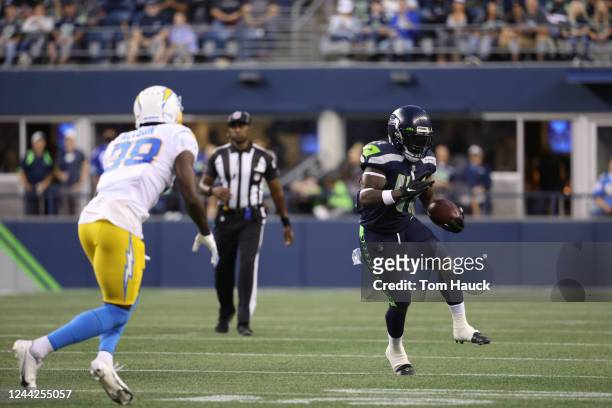 Seattle Seahawks running back Alex Collins runs with the ball during an NFL preseason football game between the Seattle Seahawks and the Los Angeles...