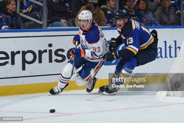 Ryan Nugent-Hopkins of the Edmonton Oilers and Alexey Toropchenko of the St. Louis Blues battle for the puck at the Enterprise Center on October 26,...