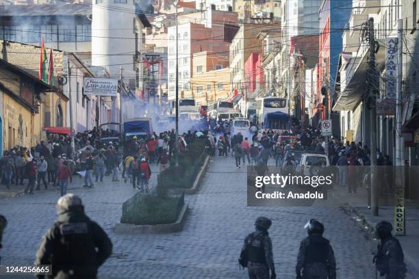 Police disperse protesters during clashes between supporters and opponents of Luis Arce in La Paz, Bolivia on October 27, 2022. Supporters of...