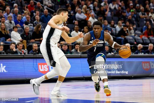 Anthony Edwards of the Minnesota Timberwolves dribbles the ball to the basket while Doug McDermott of the San Antonio Spurs defends in the fourth...