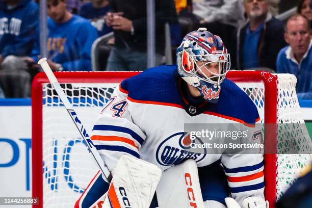 Edmonton Oilers goaltender Stuart Skinner watches the puck in the corner during the third period of an NHL hockey game between the St. Louis Blues...