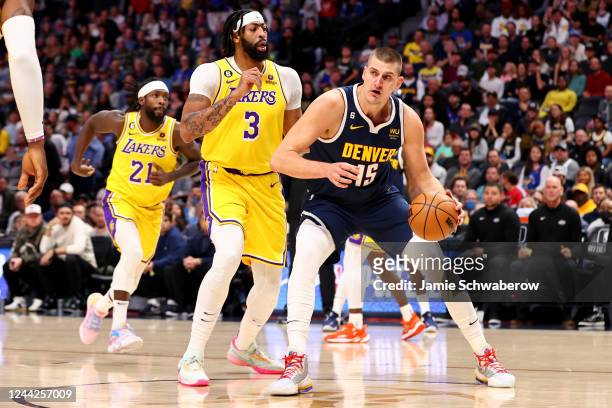 Nikola Jokic of the Denver Nuggets drives against Anthony Davis of the Los Angeles Lakers at Ball Arena on October 26, 2022 in Denver, Colorado....