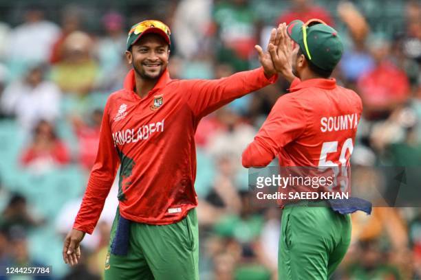 Bangladesh's captain Shakib Al Hasan and Soumya Sarkar celebrate the wicket of South Africa's Quinton de Kock during the ICC men's Twenty20 World Cup...