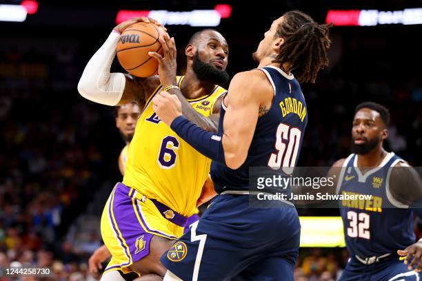 LeBron James of the Los Angeles Lakers drives against Aaron Gordon of the Denver Nuggets at Ball Arena on October 26, 2022 in Denver, Colorado. (NOTE...