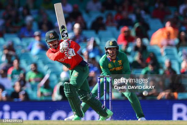 Bangladesh's Litton Das plays a shot in front of South Africa's Quinton de Kock during the ICC men's Twenty20 World Cup 2022 cricket match between...