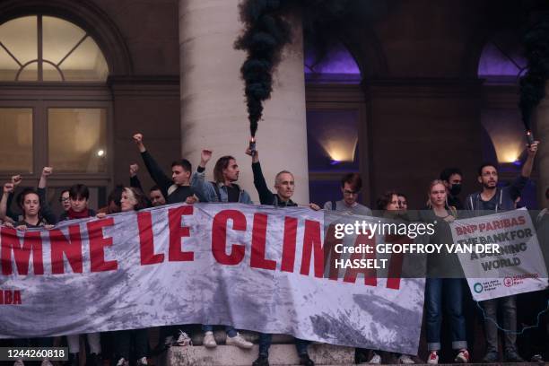 Activists of 'Les Amis de la Terre' and 'Alternatiba' collectives participate in an action against the Climate Finance Day event in Paris on October...