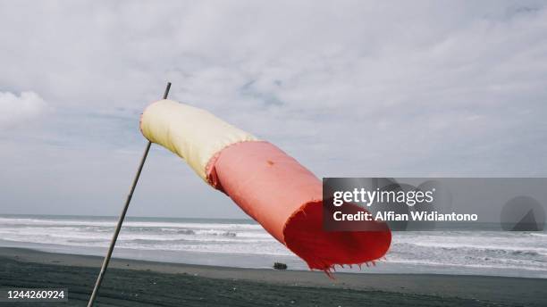 empty beach - wind sock stock pictures, royalty-free photos & images