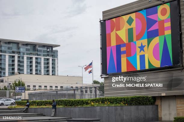 United States of America flag and a rainbow flag are seen waving from the US consulate next to a billboard of the upcoming Johannesburg Pride event...