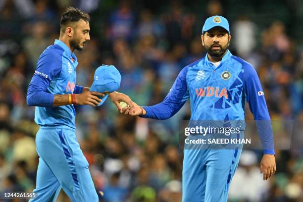 India's captain Rohit Sharma gives the ball to India's Axar Patel during the ICC men's Twenty20 World Cup 2022 cricket match between India and...