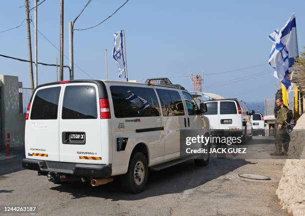 Vehicles of an Israeli delegation convoy cross the border between Rosh HaNikra in northern Israel and Lebanon's southern Naqoura to make their way...