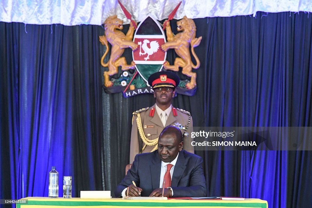 President Ruto Swearing In Kenya's President William Ruto, signing an oath of office during a ...