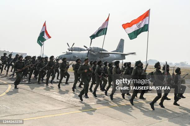 Indian army soldiers take part in a 75th anniversary function reenacting the 1947 landings of Indian troops in Srinagar, at Budgam airfield in...