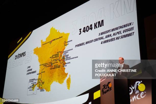 Tour de France General Director Christian Prudhomme speaks next to the map displaying the men's 2023 Tour de France route during the official...