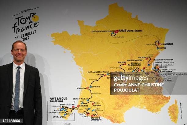 Tour de France General Director Christian Prudhomme poses with the map displaying the men's 2023 Tour de France route during the official...