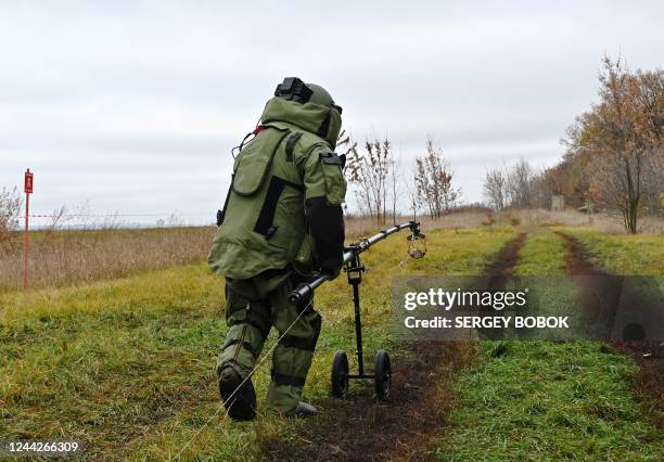 Deminer of the State Emergency Service of Ukraine walks during a presentation to media of Ukraines first Armtrac 400 specialized mine clearance...