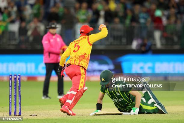 Zimbabwe's Regis Chakabva celebrates the victory as Pakistan's Shaheen Shah Afridi lies on the pitch at the end of the ICC mens Twenty20 World Cup...