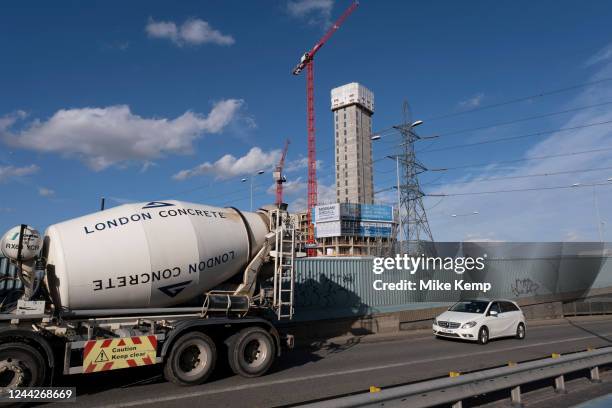 Traffic including a London Concrete cement mixer pass nearby high rise apartment block buildings under construction on the A13 on 17th October 2022...