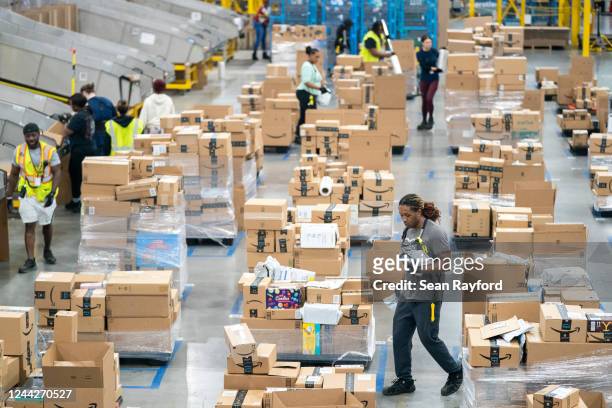 Workers sort packages by zip code during a media tour of the Amazon AGS5 facility on October 27, 2022 in Appling, Georgia. Amazon, the leading United...