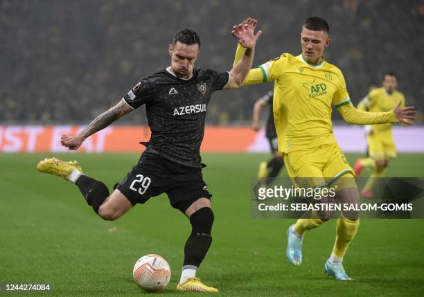 Qarabag's Montenegrin defender Marko Vesovic shoots the ball as Nantes' France's forward Quentin Merlin looks on during the UEFA Europa League Group...