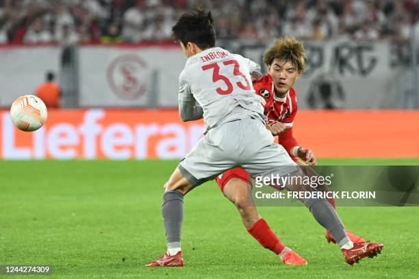 Olympiacos' South Korean midfielder In-beom Hwang and Freiburg's Japanese midfielder Ritsu Doan vie for the ball during the UEFA Europa League Group...