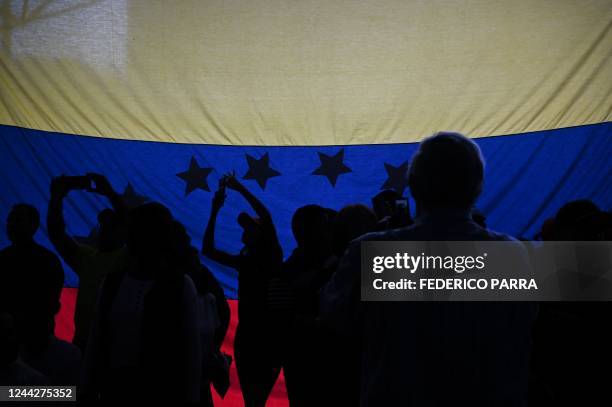 Supporters of Venezuelan opposition leader Juan Guaido attend a demonstration to demand a date for presidential elections, in Caracas on October 27,...