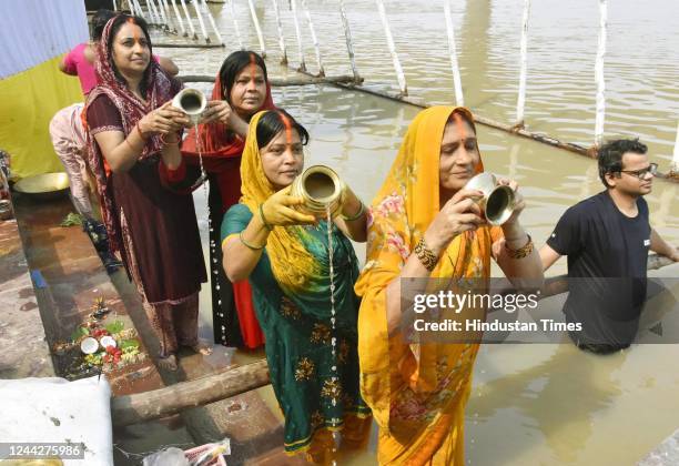 Chhath devotees perform rituals at the bank of Ganga river at Gandhi Ghat on the eve of Chhath Puja festival on October 27, 2022 in Patna, India....