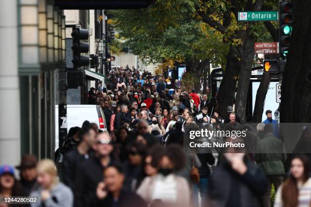 People walk the sidewalk in Chicago, United States on October 14, 2022.