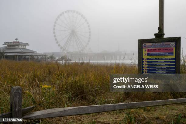 Sign on the beach near Steel Pier in Atlantic City, New Jersey on October 26, 2022. - Ten years after the devastating hurricane Sandy, the seaside...