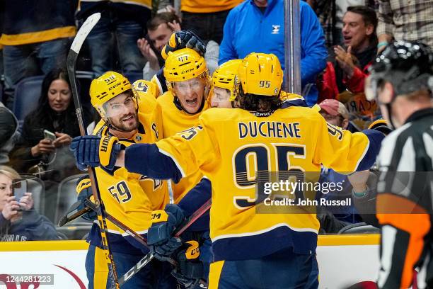 Michael McCarron celebrates his goal with Roman Josi and Matt Duchene of the Nashville Predators against the St. Louis Blues during an NHL game at...