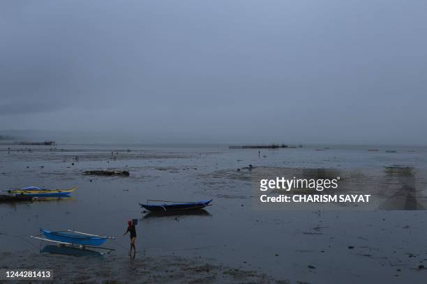 Fishermen unload their catch along the bay in Sorsogon, in the Philippines' Sorsogon province on October 28 ahead of the expected landfall of...