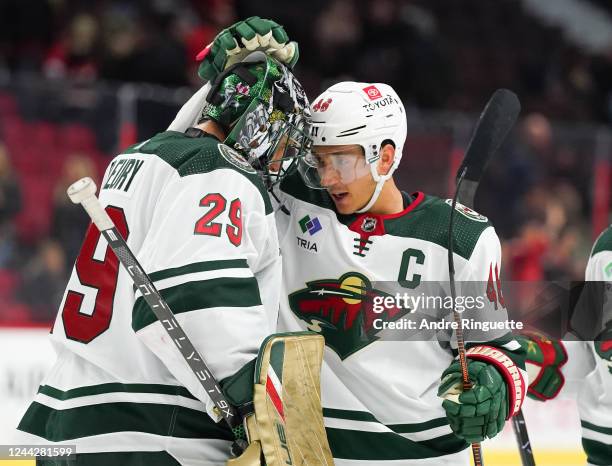 Marc-Andre Fleury and Jared Spurgeon of the Minnesota Wild celebrate their 4-2 win over the Ottawa Senators at Canadian Tire Centre on October 27,...