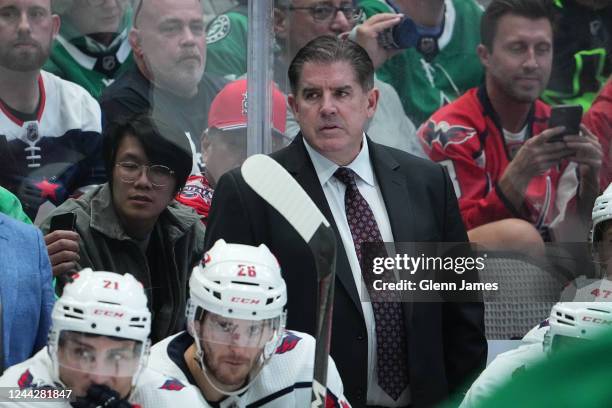 Peter Laviolette of the Washington Capitals watches the action from behind the bench against the Dallas Stars at the American Airlines Center on...