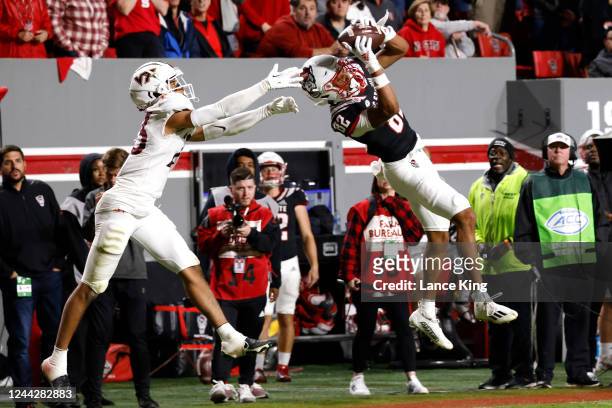 Terrell Timmons Jr. #82 of the North Carolina State Wolfpack misses a pass against Mansoor Delane of the Virginia Tech Hokies during the second half...