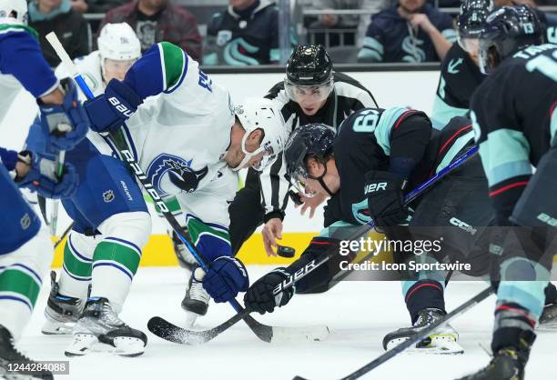 Vancouver Canucks center Bo Horvat and Seattle Kraken center Morgan Geekie face-off during an NHL game between the Vancouver Canucks and the Seattle...