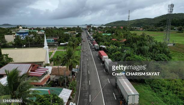 This aerial pictures shows dozens of cargo trucks lined up along a highway near Matnog pier, in Sorsogon province, south of manila on October 28...