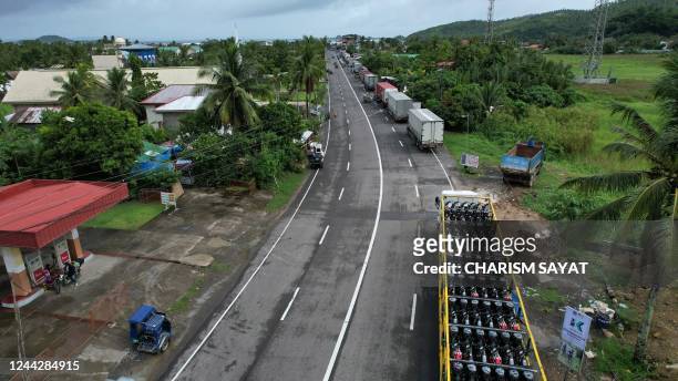 This aerial pictures shows dozens of cargo trucks lined up along a highway near Matnog pier, in Sorsogon province, south of manila on October 28...