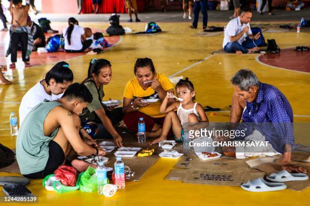 Stranded passengers take a rest inside a gymnasium in Matnog town, Sorsogon province, south of manila on October 28 after authorities halted ferry...