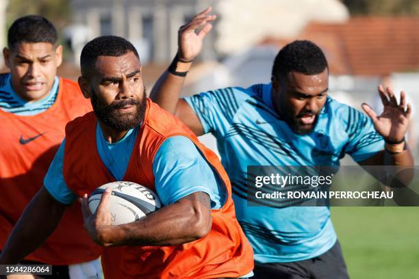 Fidji centre Andrea Cocagi runs with the ball during a training session with teammates at the Jean Antoine Moueix stadium in Libourne, on October 26,...