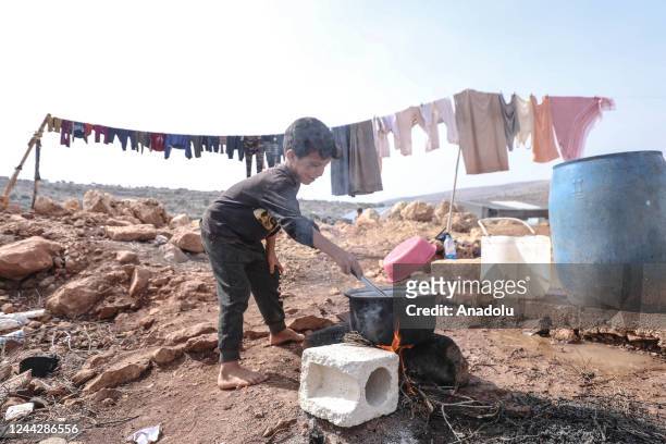 Syrian refugee child is seen making preparations for winter conditions in a tent camp in Idlib, Syria on October 18, 2022.