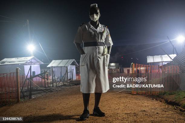 Photo taken October 27 shows Jane Apunyo, head nurse Mubende referral hospital during a night supervision at the Ebola treatment center in...