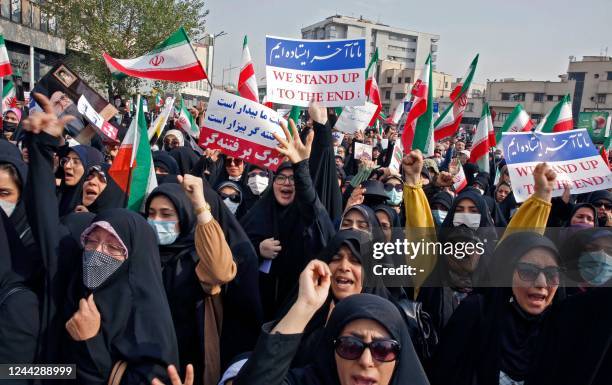 Iranians rally in the capital Tehran to denounce a mass shooting at a key shrine that killed more than a dozen worshippers, on October 28, 2022. -...