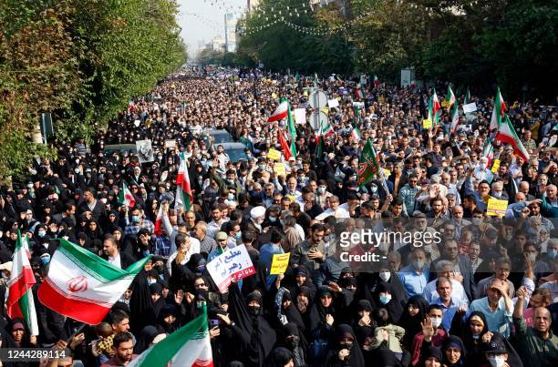 Iranians rally in the capital Tehran to denounce a mass shooting at a key shrine that killed more than a dozen worshippers, on October 28, 2022. -...