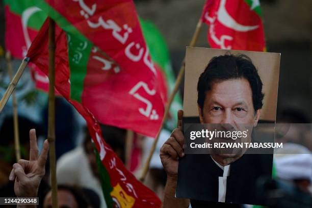 Activists of opposition party Pakistan Tehreek-e-Insaf take part of anti-government rally demanding early election in Karachi on October 28, 2022. -...